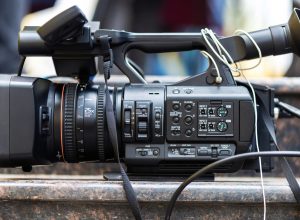 Professional video camera with cables on stone stairs